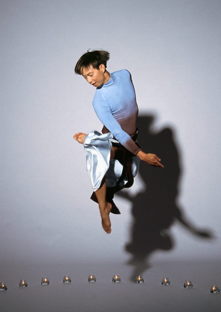 Minh Tran caught mid jump, dancing in the air.