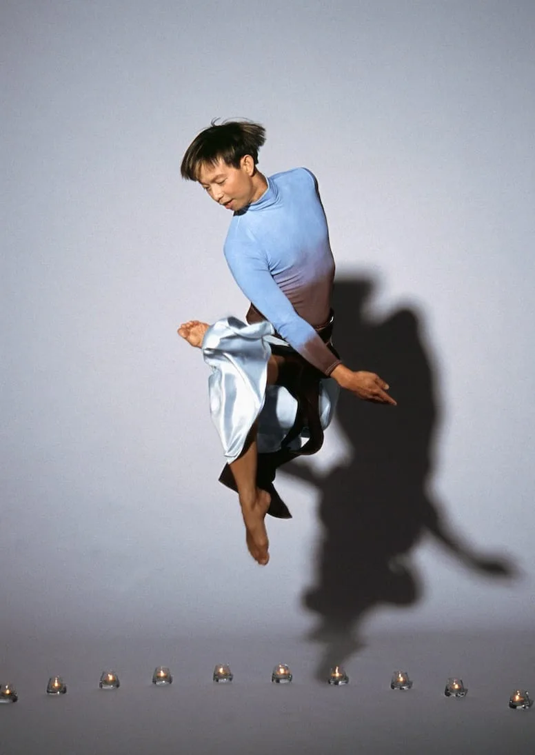 Minh Tran caught mid jump, dancing in the air.